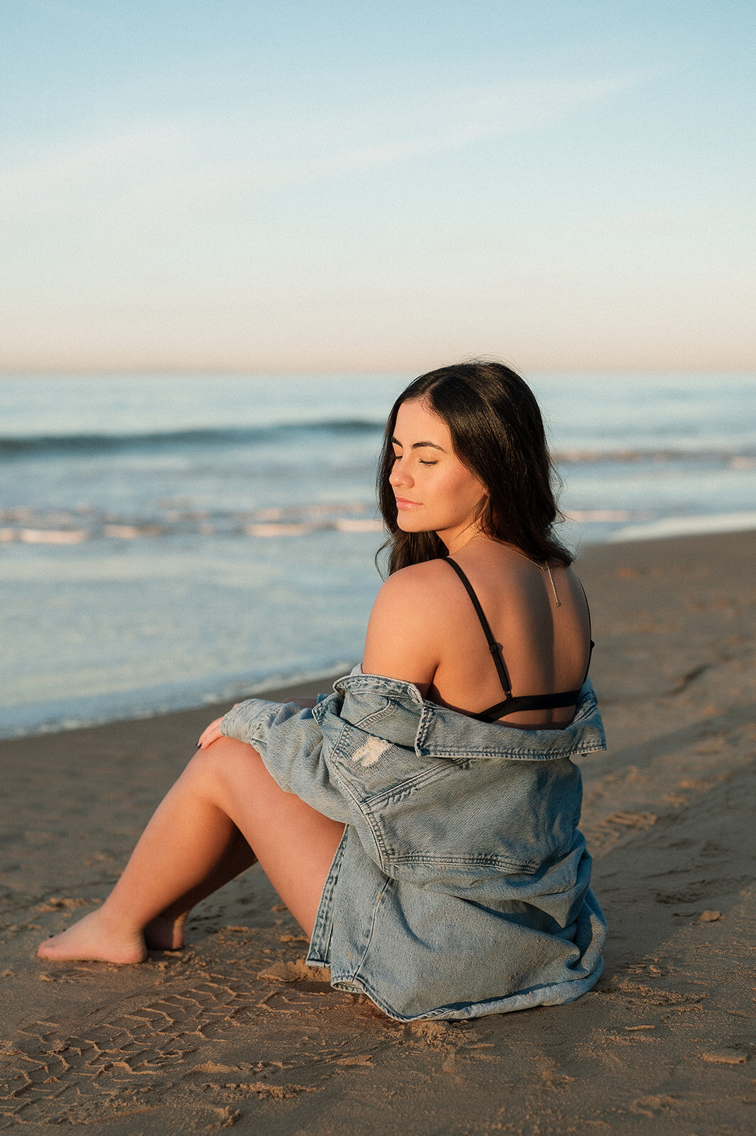 photo of senior sitting in the sand