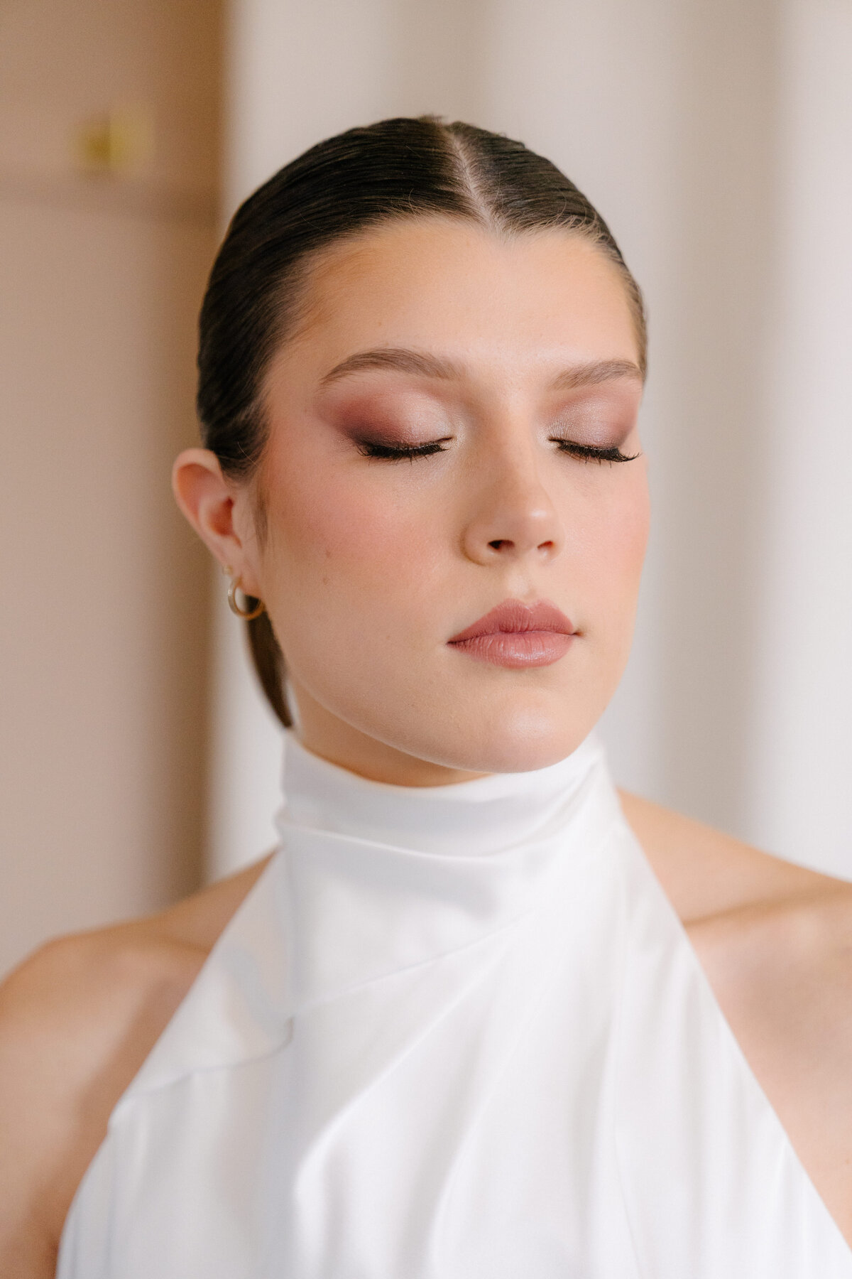 Bride with soft glam makeup and sleek updo in Chicago, IL. Wedding beauty services.