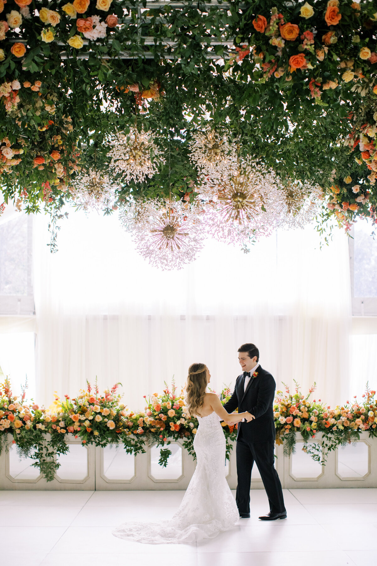 Beautiful first look under tent with bright florals in Memphis