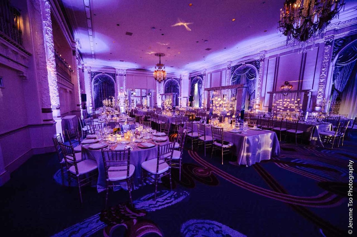 wedding reception at Fairmont Olympic Hotel with blue lighting and gold Chivari chairs