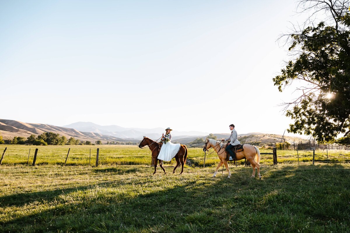 A couple riding horses at their wedding in Idaho