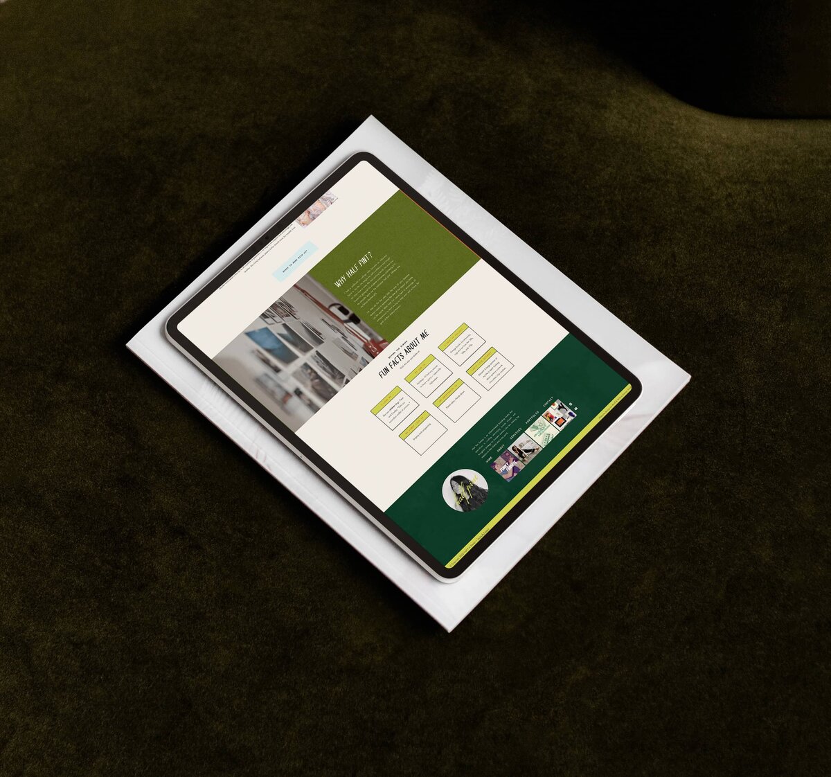 A tablet displaying a website with a green and white color scheme, created by a branding designer, is placed on top of a closed laptop against a dark green background.