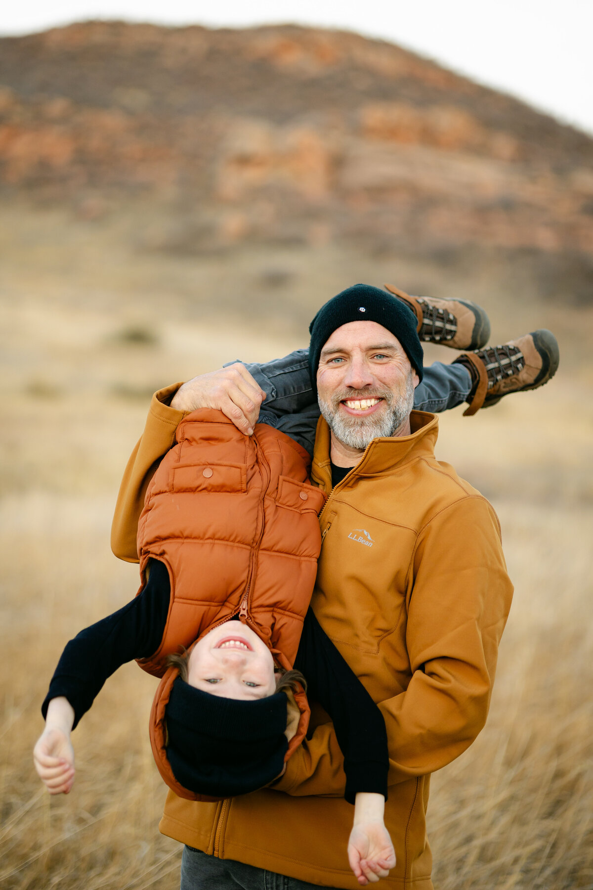 A father flips his son upside down at Lory State Park in Fort Collins, Colorado.