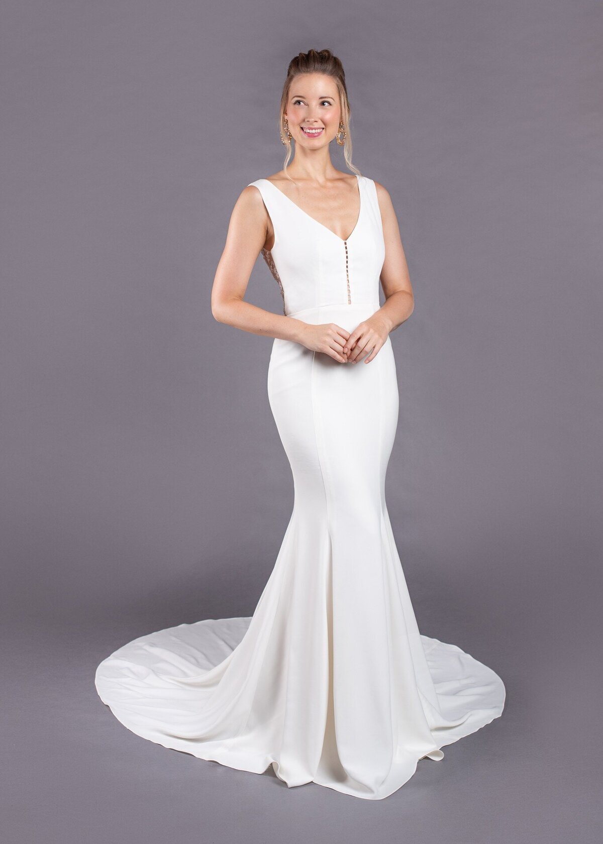 The Jane bridal style is a crepe wedding gown in a fit-and-flare silhouette with a pearl embellished v-neck bodice.