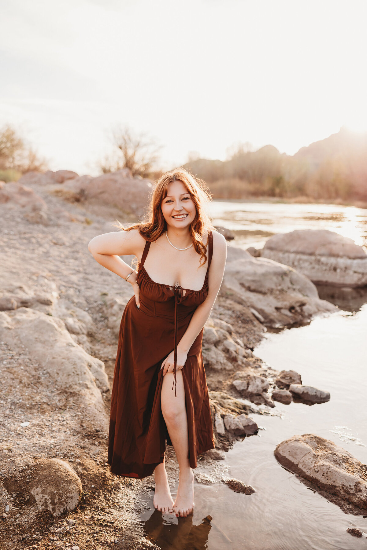 Girl with red hair posing at salt river for senior session by phoenix photographer