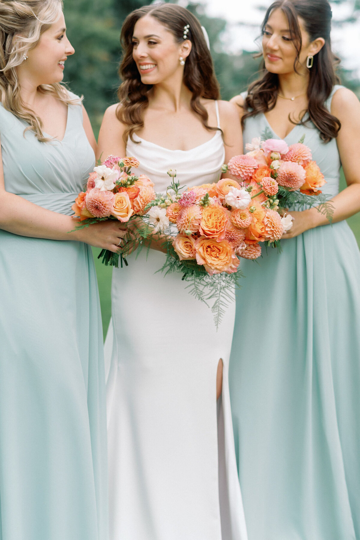 Colourful bridesmaids bouquets, captured by Kaity Body Photography, elegant film inspired wedding photographer in Calgary, Alberta. Featured on the Bronte Bride Vendor Guide