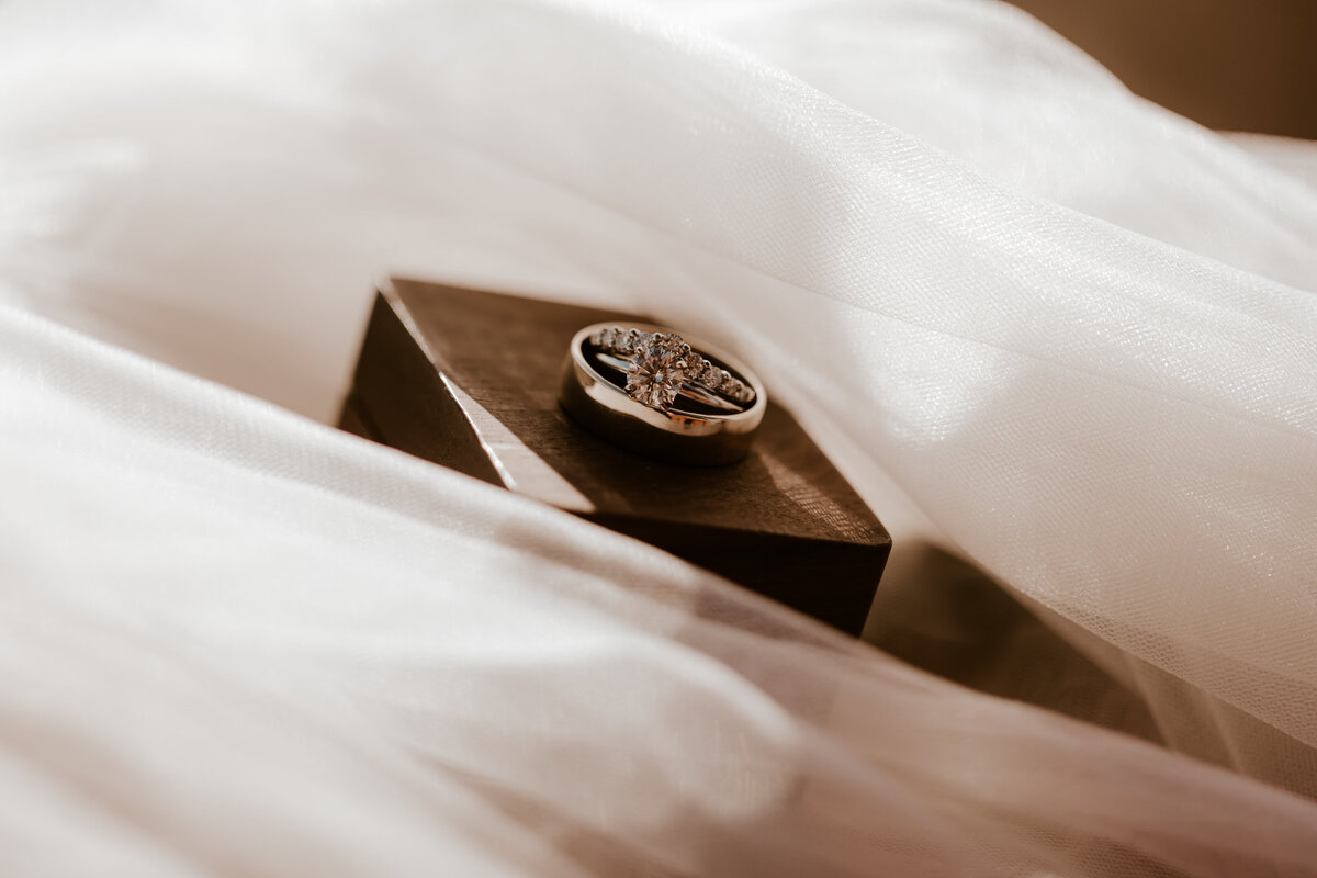 WEDDING RINGS ON RING BOX ON BRIDES VEIL GROOMS COWBOY HAT