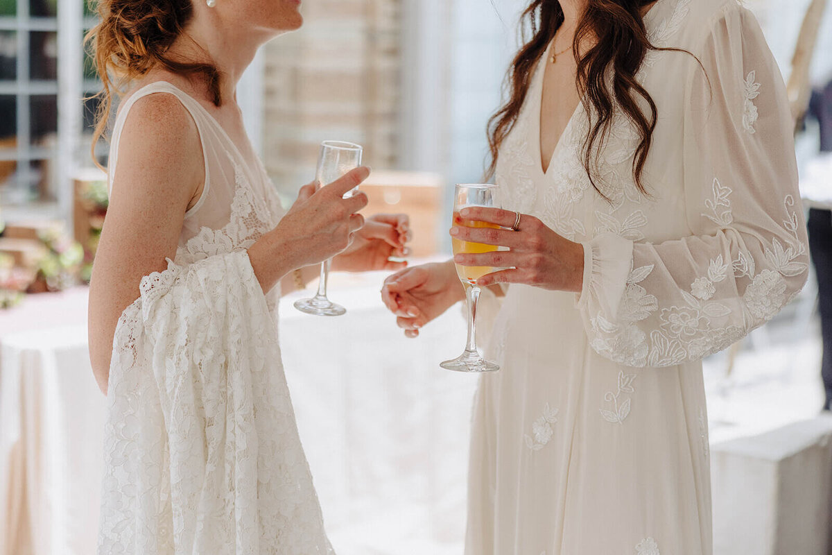 Brides holding drinks at Cornell University wedding reception