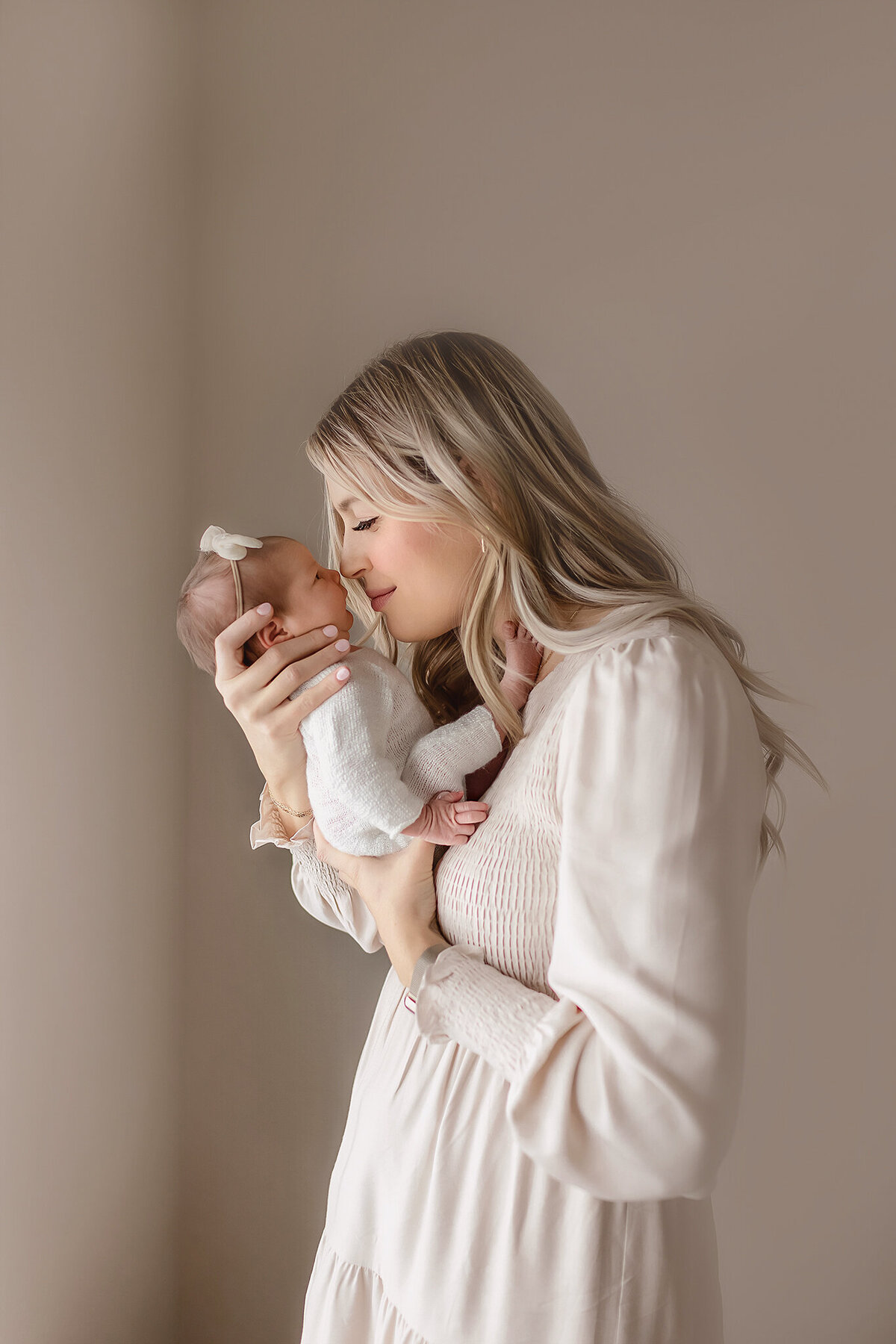 A baby stretches their tiny fingers in this pure and natural newborn photo, taken in a softly lit Denver home.