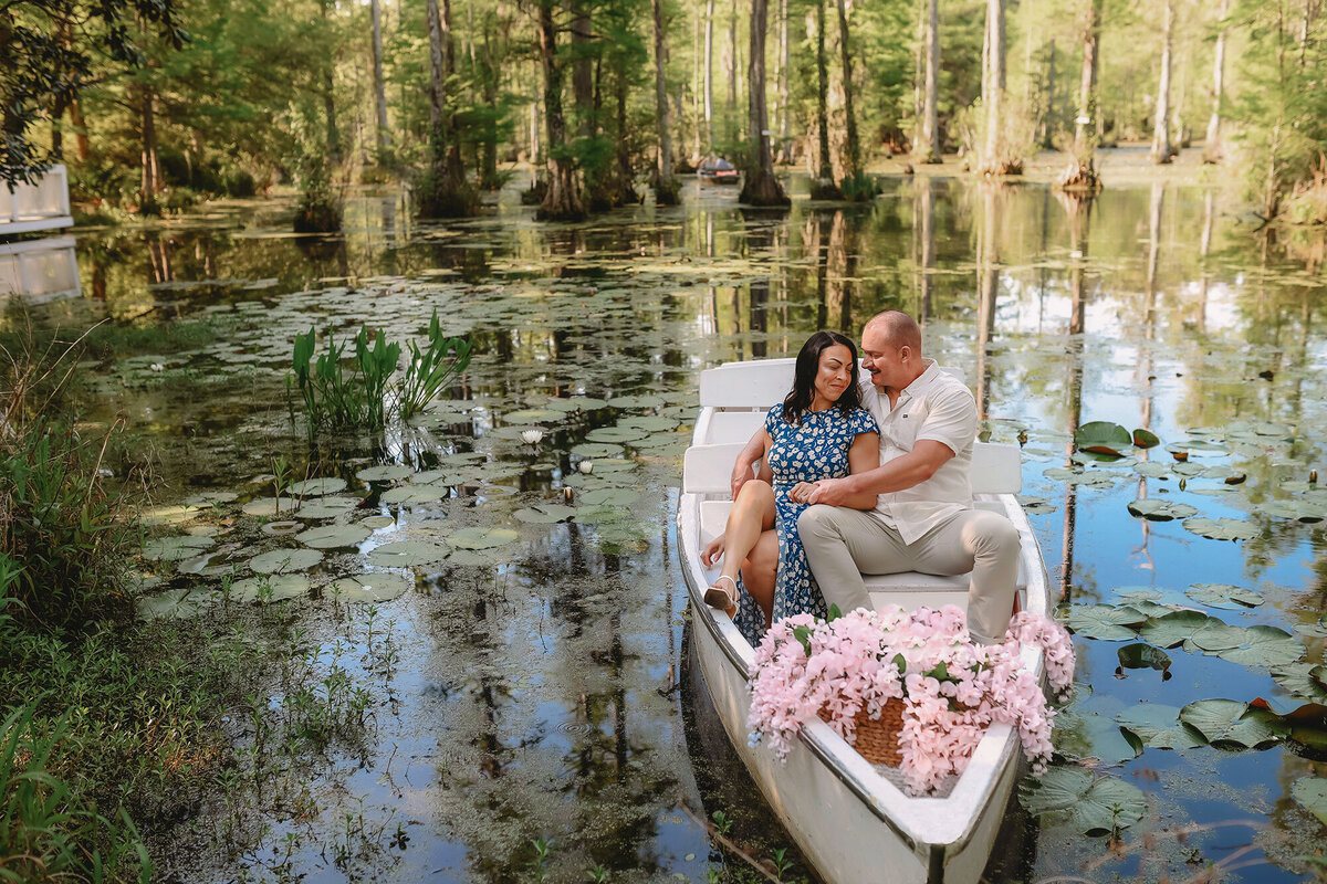 Couple snuggles with each other during their Engagement Photos at Cypress Gardens. 