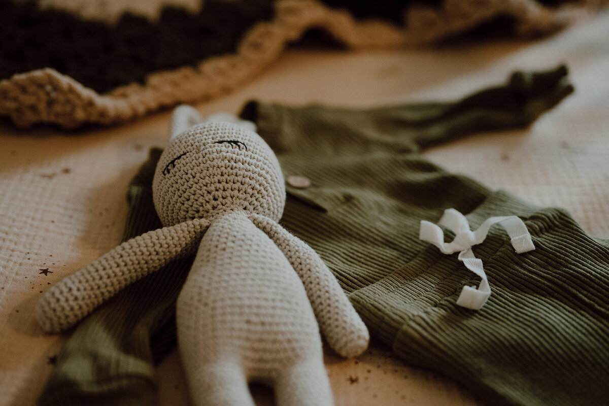 Detail shot of a baby toy and outfit 