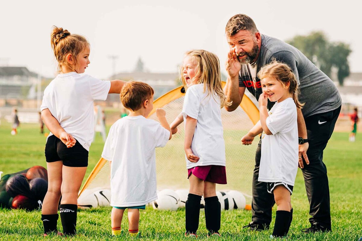 Missoula Strikers coach with kids at soccer practice, Playfair Park, Missoula