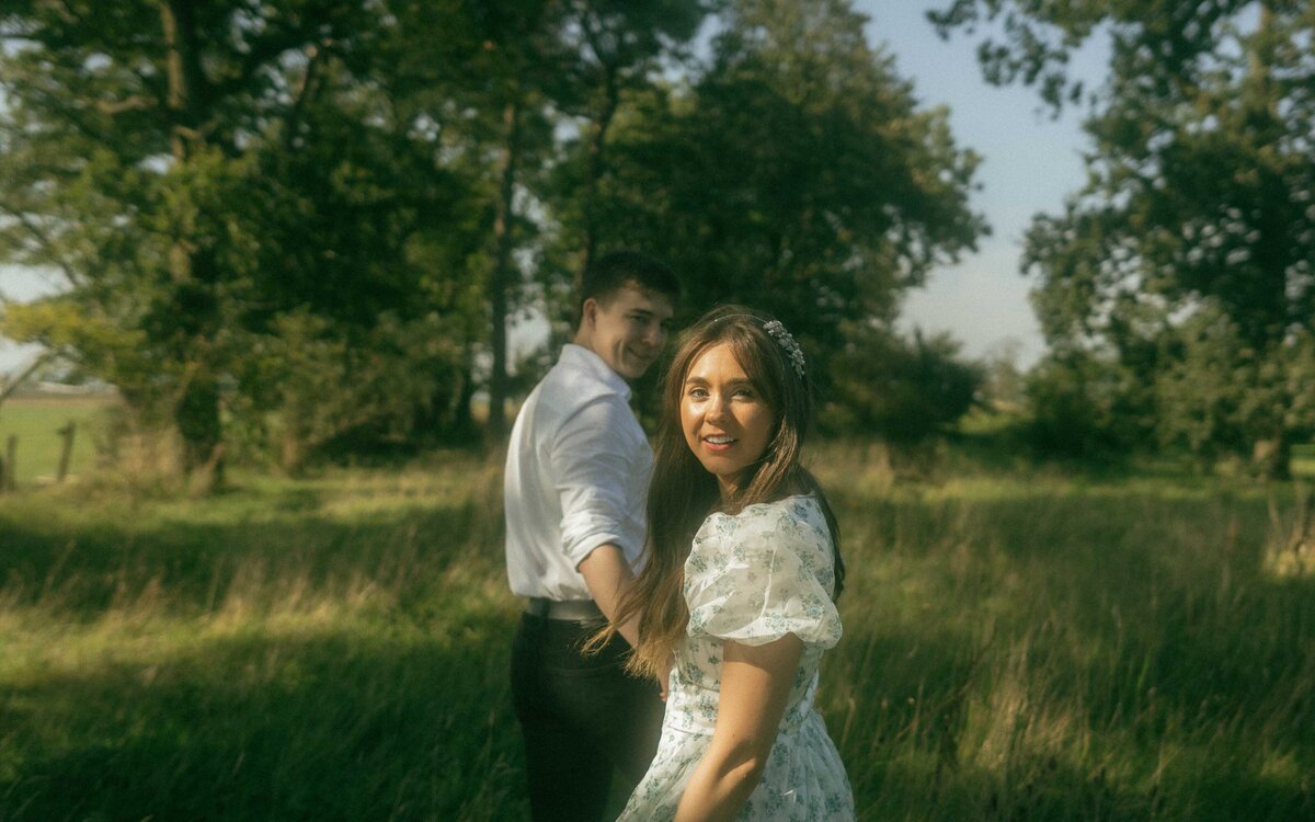 A beautiful couple photoshoot featuring a woman looking confidently at the camera, capturing a timeless and intimate moment. Perfect for lasting memories
