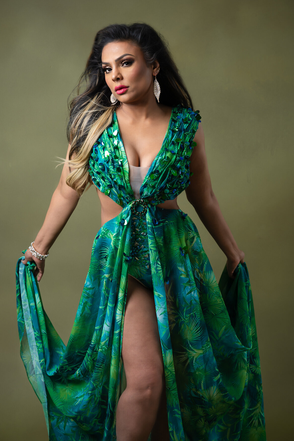 Woman wearing a green gown with a lep open