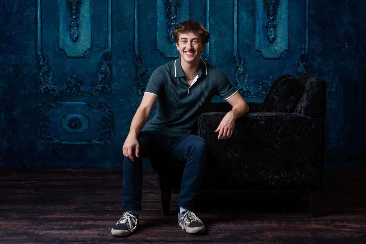 Boy poses in black chair for Prescott senior photographer Melissa Byrne