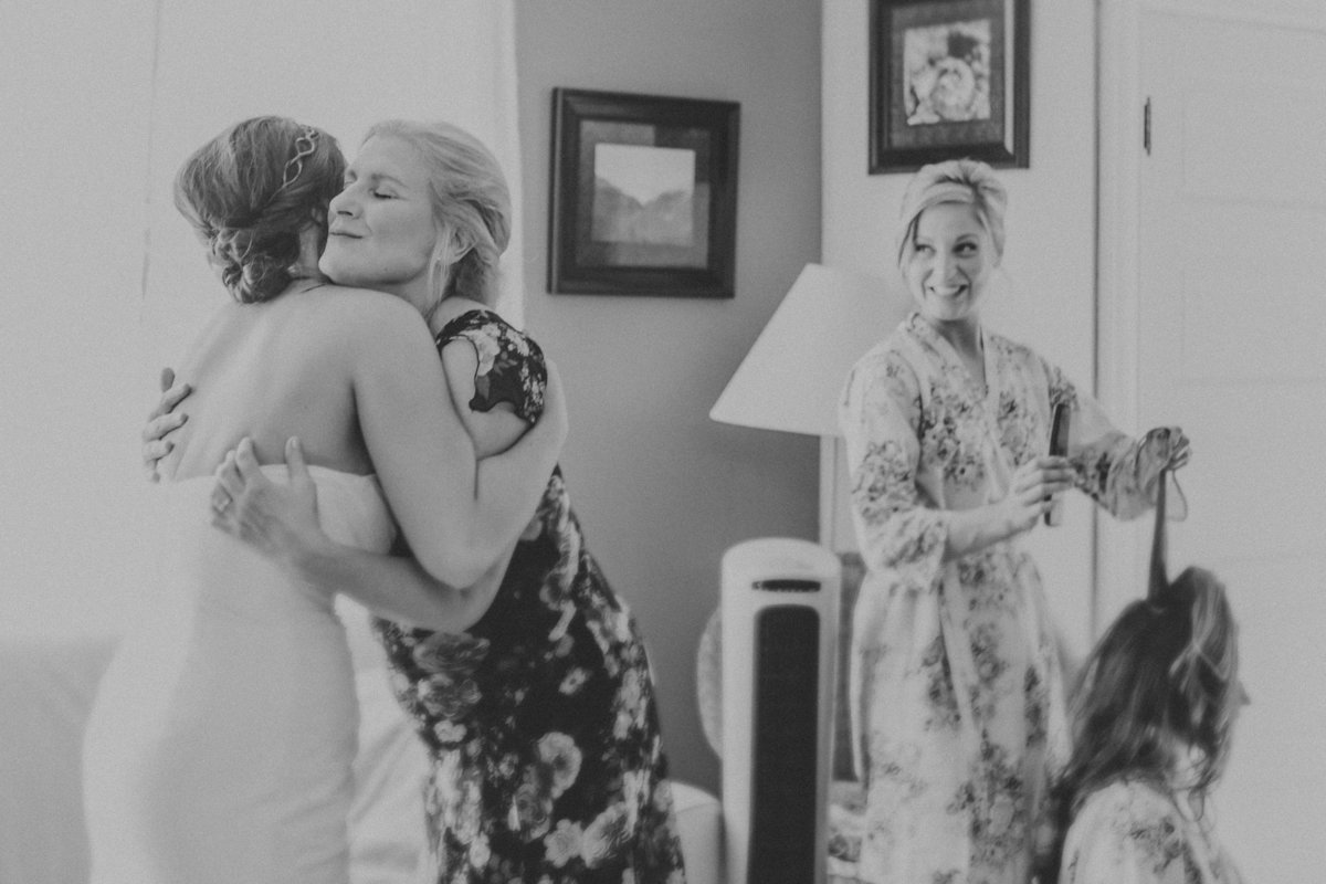 wedding photo of mother of the bride hugging her  daughter | Susie Moreno Photography
