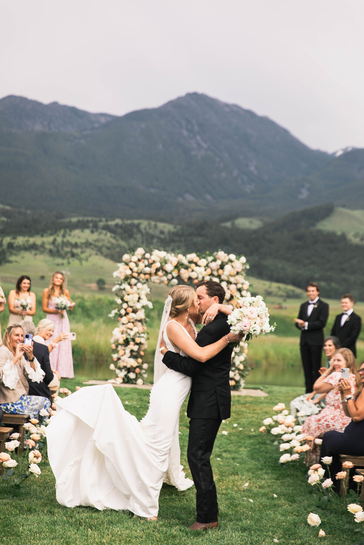 bride and groom kissing after ceremony