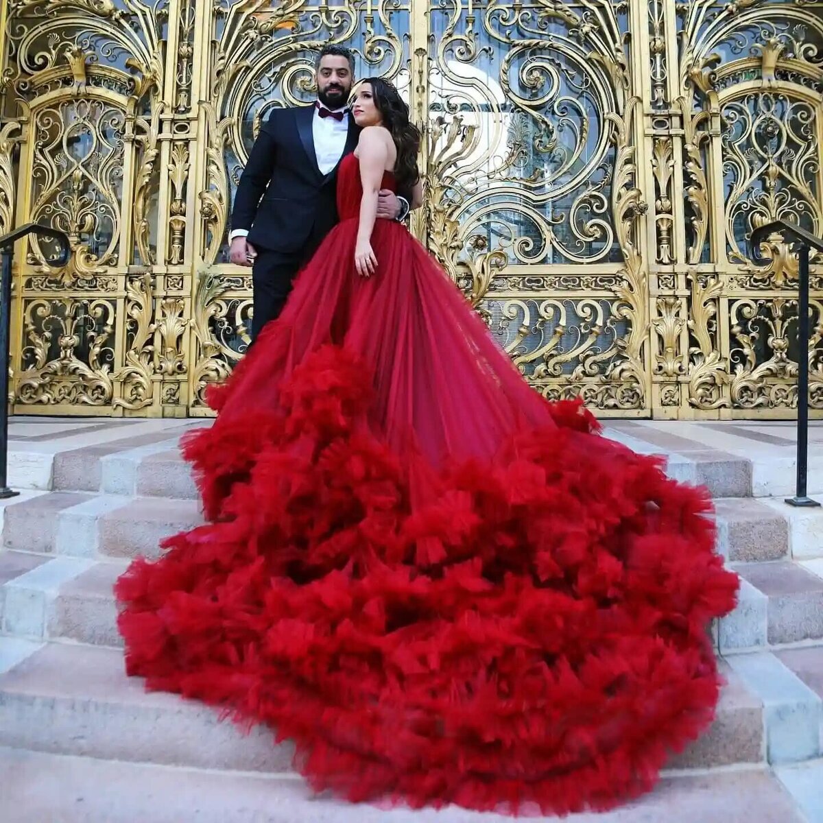 a couple having a photoshoot in paris with a red dress