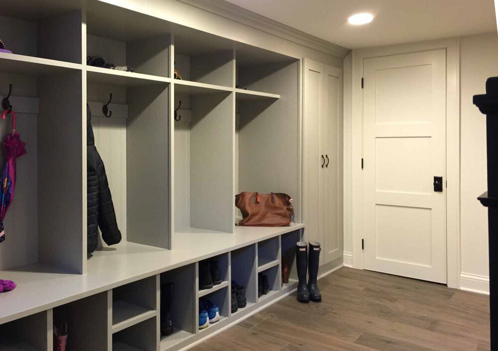 Mudroom design with white built in storage shelves
