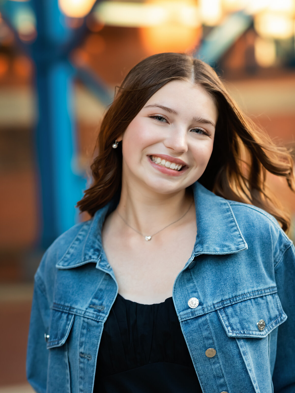 senior girl in jean jacket posed for senior portraits 