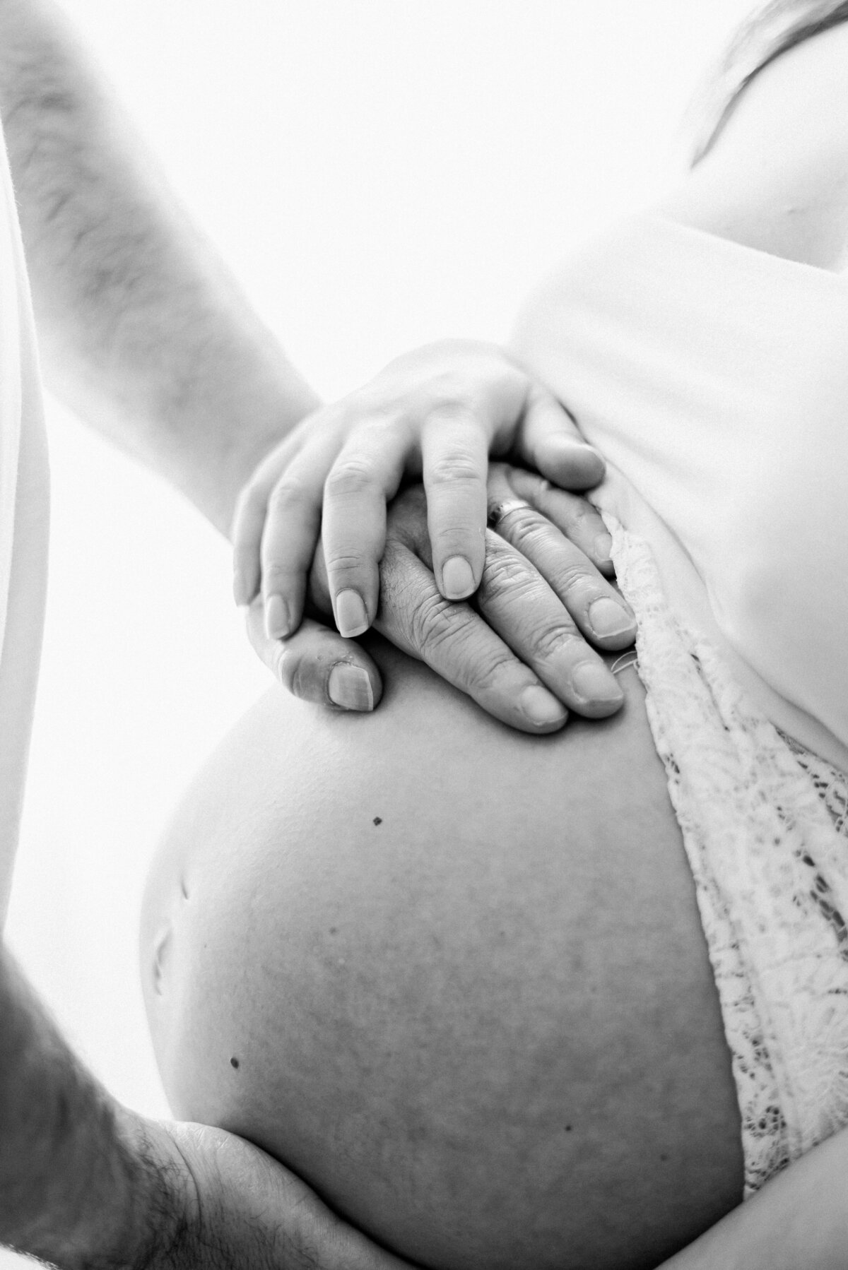 Mum and dad holding pregnant bump during billingshurst maternity photoshoot