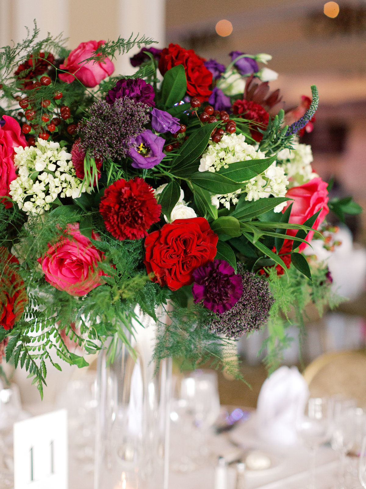 Elevated floral arrangement with jewel toned flowers