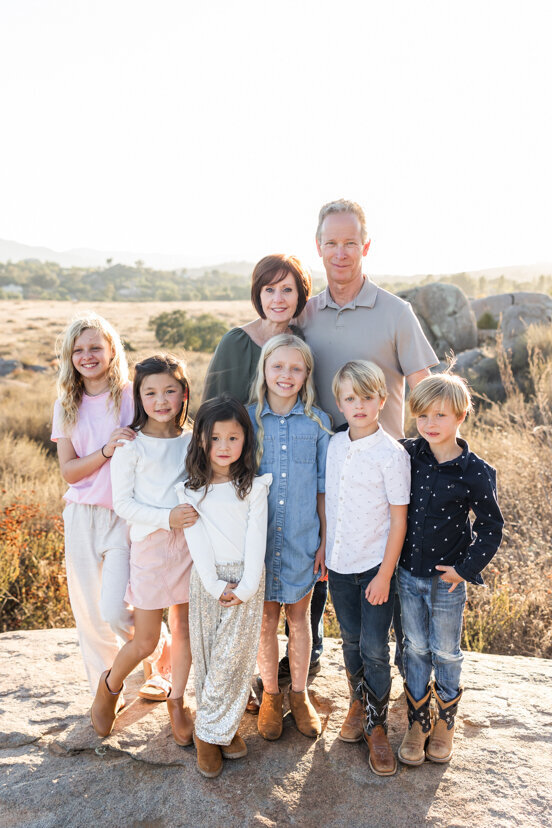 grandparents-and-grandchildren-standing-on-rock-family-of-four-sitting-on-rock-wrights-field-san-diego