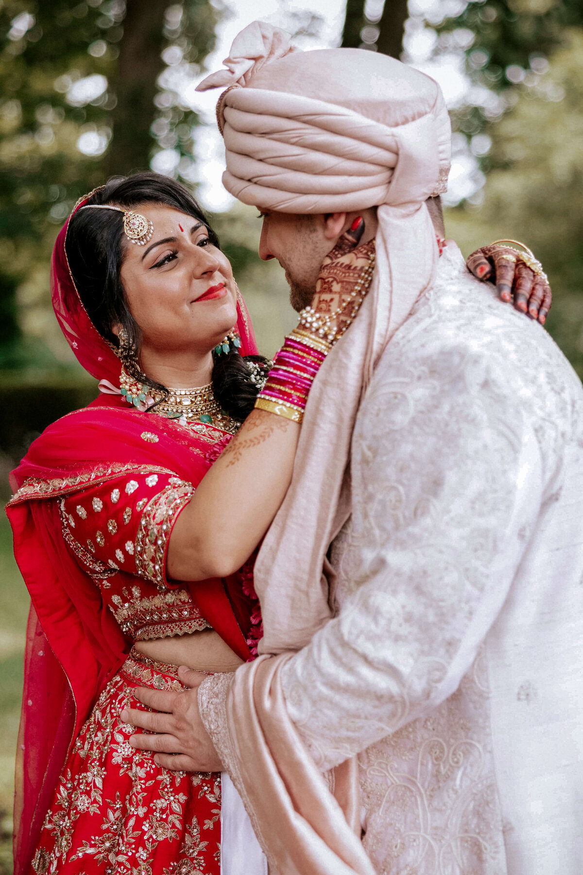 indian-bride-smiling-and-caressing-groom