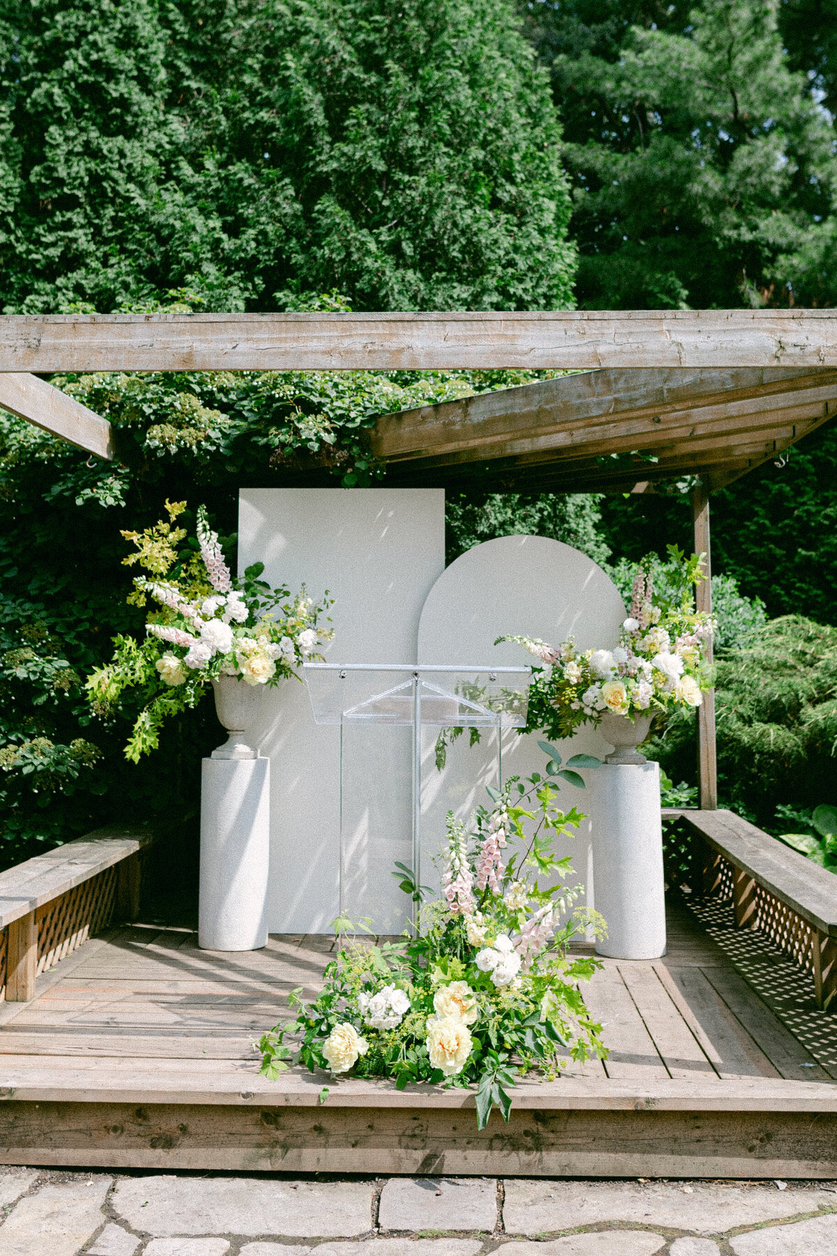 Large green flower arrangements in the garden of La Toundra for a wedding ceremony.