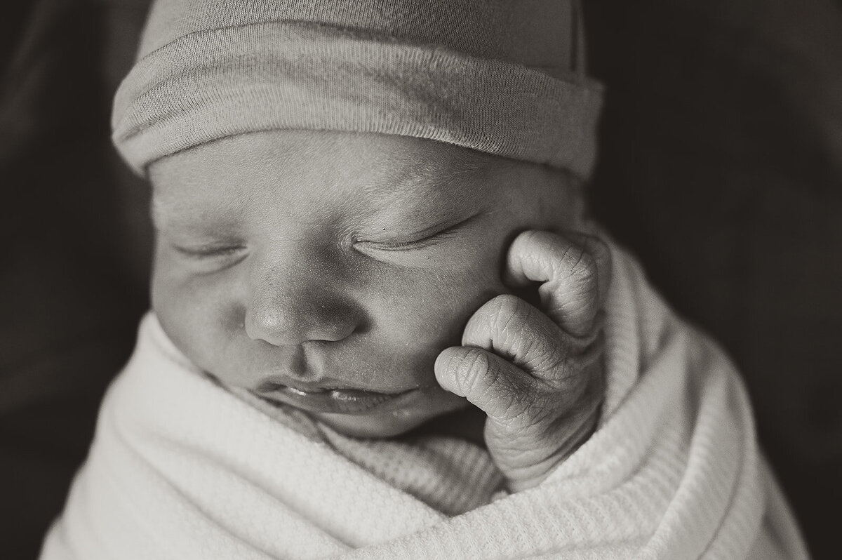 black and white detail shot of bundled up newborn baby during fresh 48 photoshoot