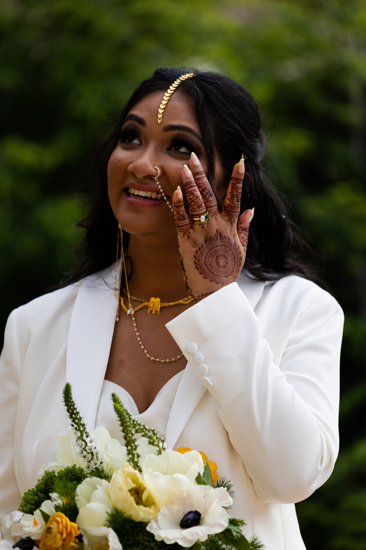 Bride in a white suit with henna and mendhi on her wedding day at Kensington Hotel in Ann Arbor