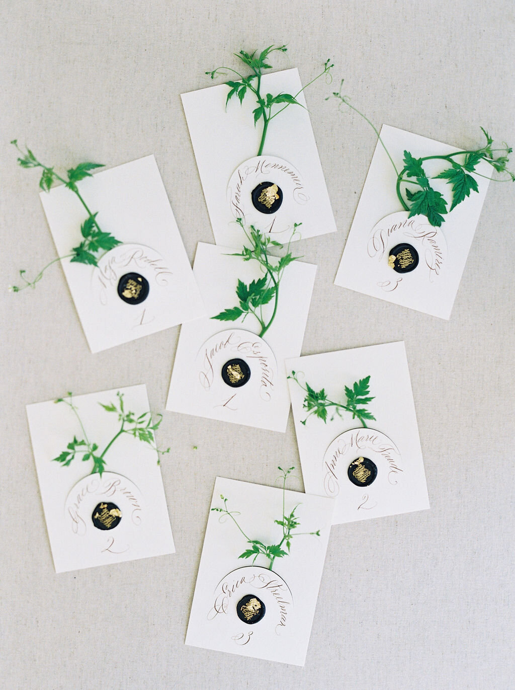 calligraphy place cards with greenery