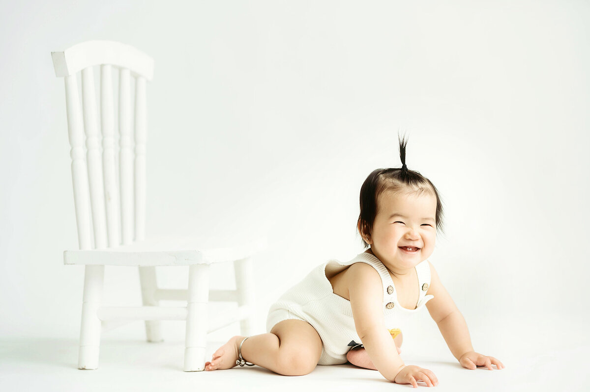 Baby laughs during xCake Smash Photoshoot in Asheville, NC.