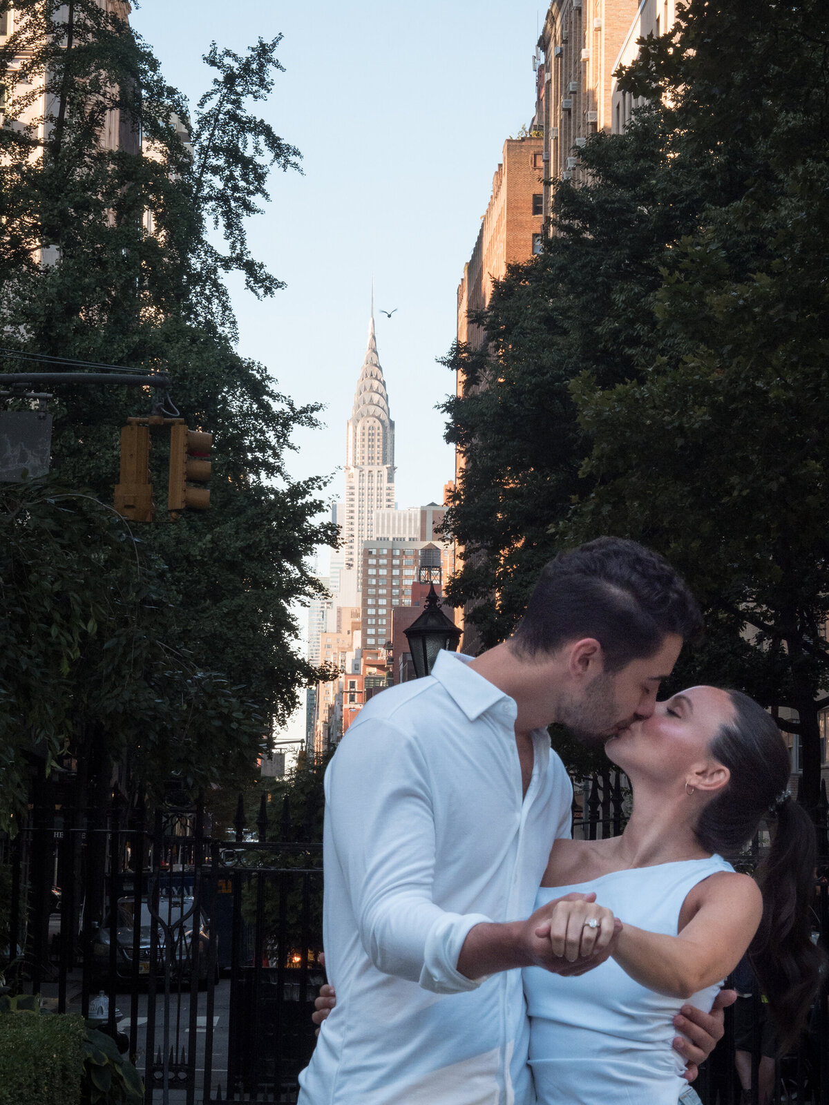 20. Engaged-couple-show-off-the-ring-with-the-Chrysler-in-the-background. Proposal-100