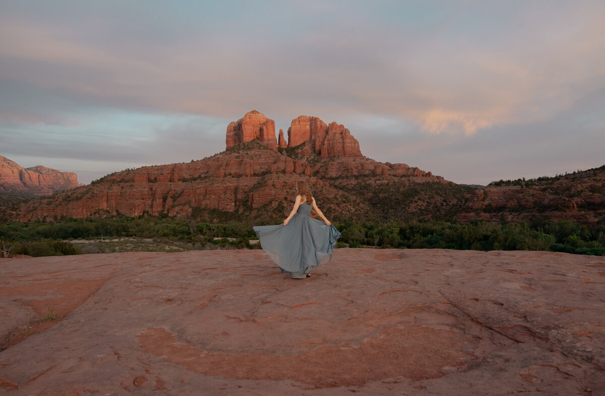 Couple standing against red rock backdrop during Sedona engagement session