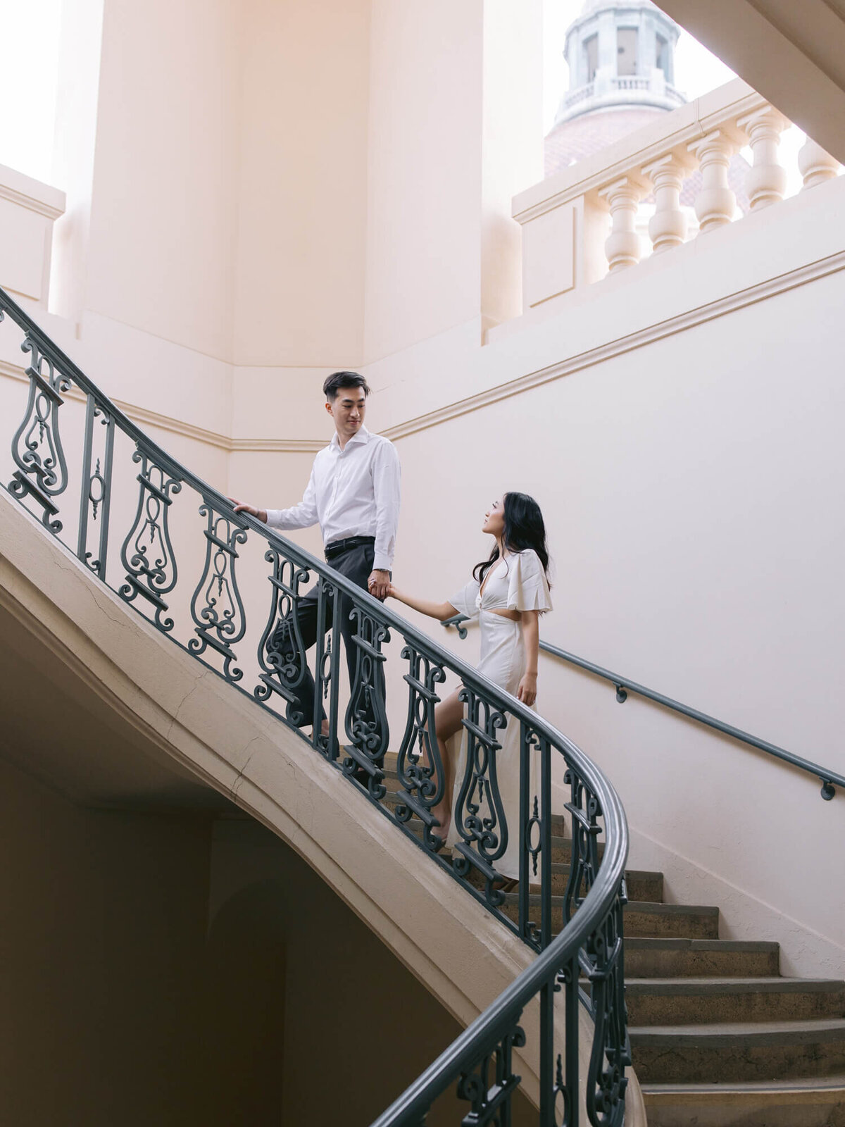 pasadena city hall engagement photo of couple walking up the stairs