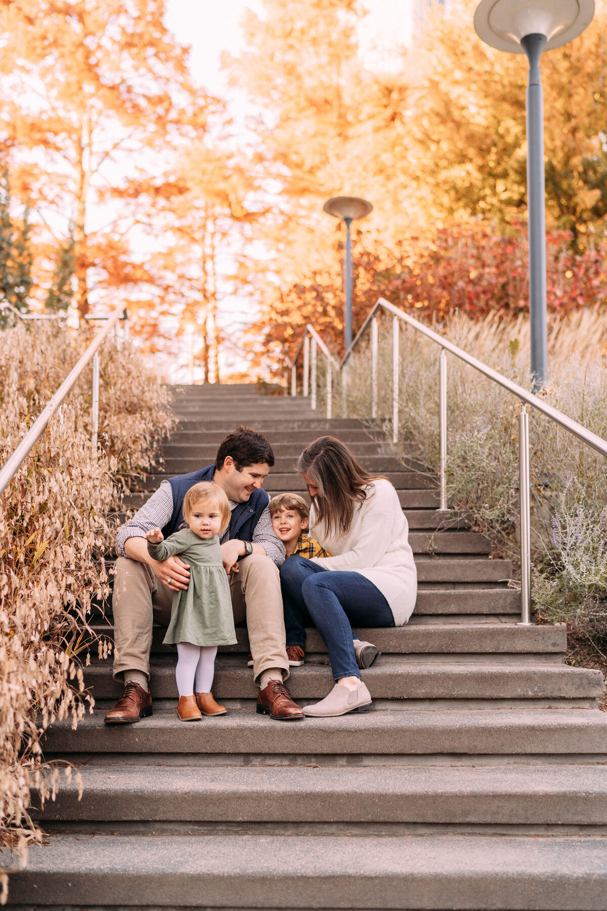 family sits on urban steps