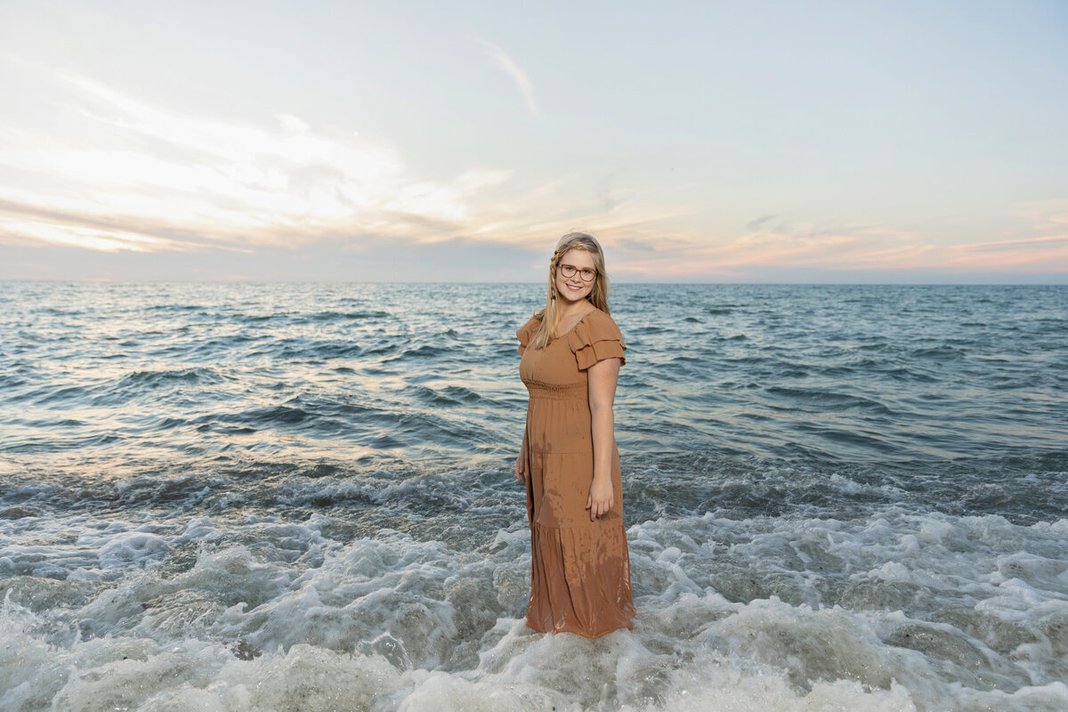 Senior photo of a girl posing in the water at Presque Isle in Erie Pa