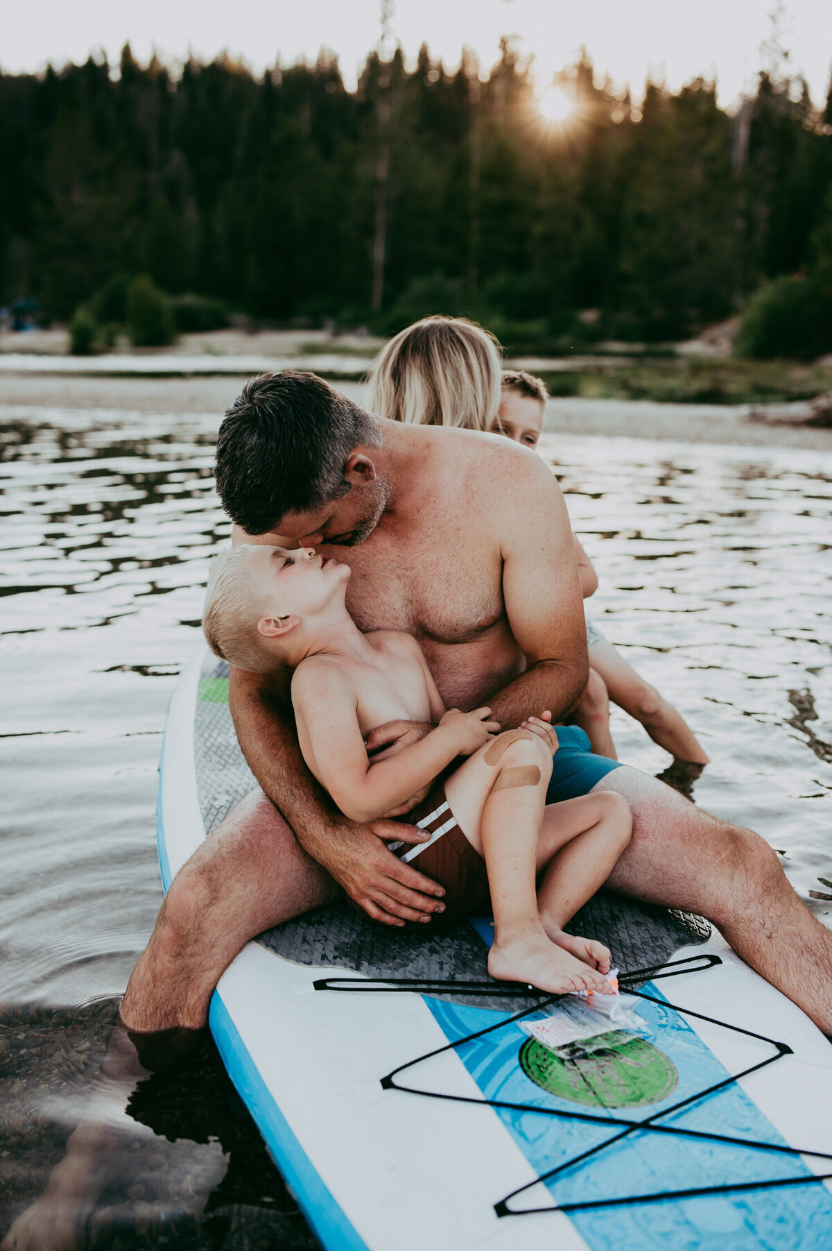 father and son on top of a paddleboard