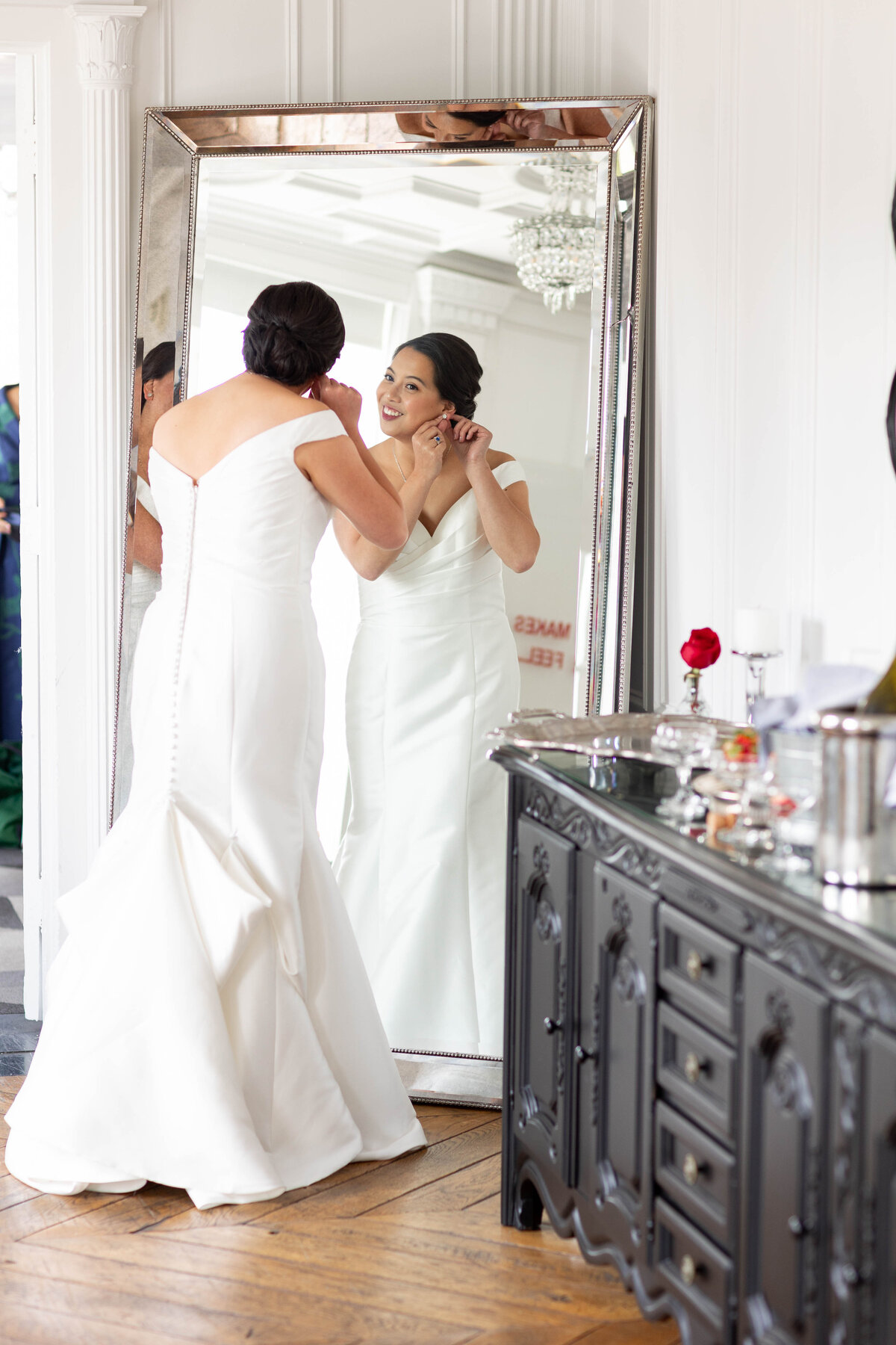 Bride looking at a long mirror