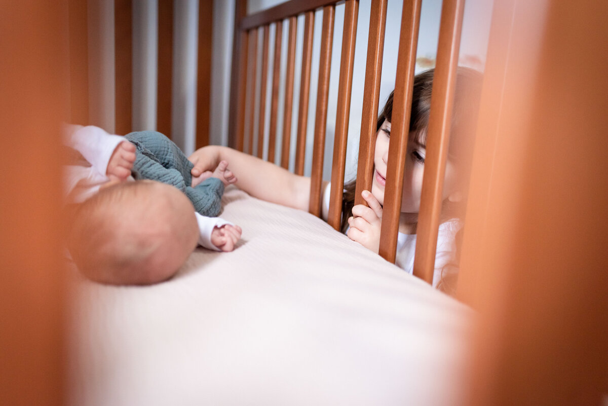 baby lifestyle nursery in crib newborn photographer northeast fort wayne bluffton indiana