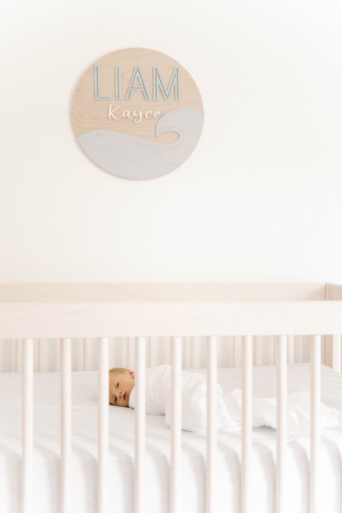 Baby lays in crib for Newborn Photography Alexandria session.