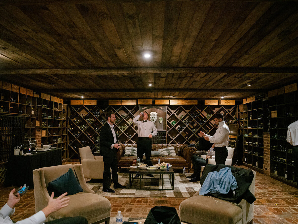 groom and groomsmen in wine cellar