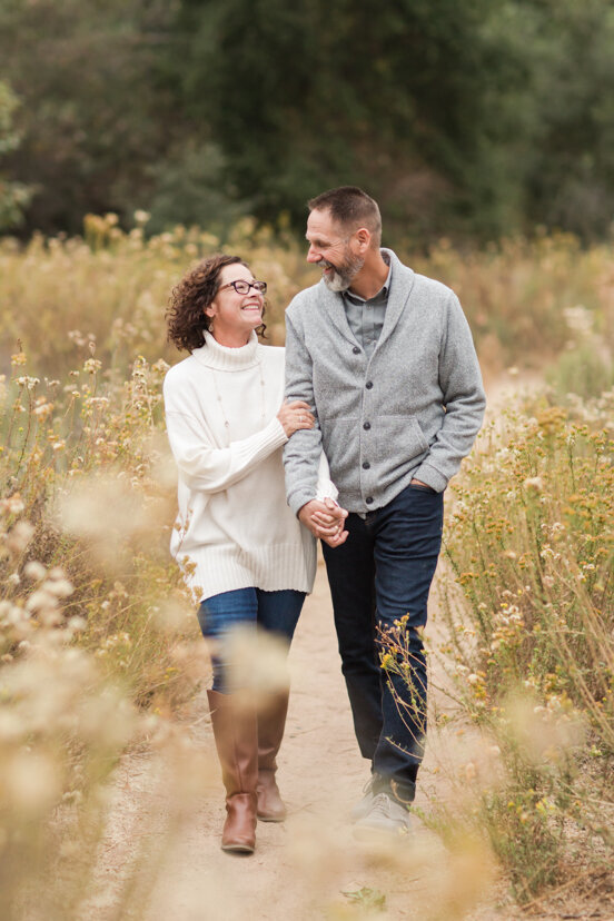 couple-walking-in-golden-field--sweetwater-river-bridge-san-diego