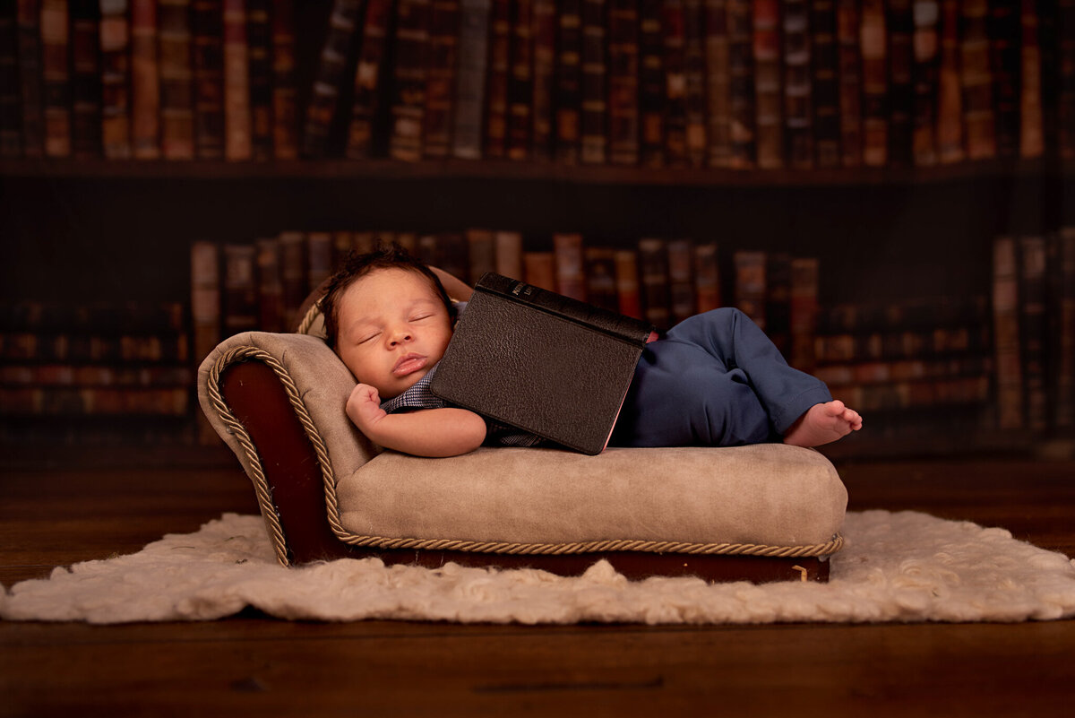 Newborn posed with books in a cozy library-inspired setup, captured in Overland Park, Kansas. Ideal for families who love literature and themed newborn photography in the Kansas City metro area