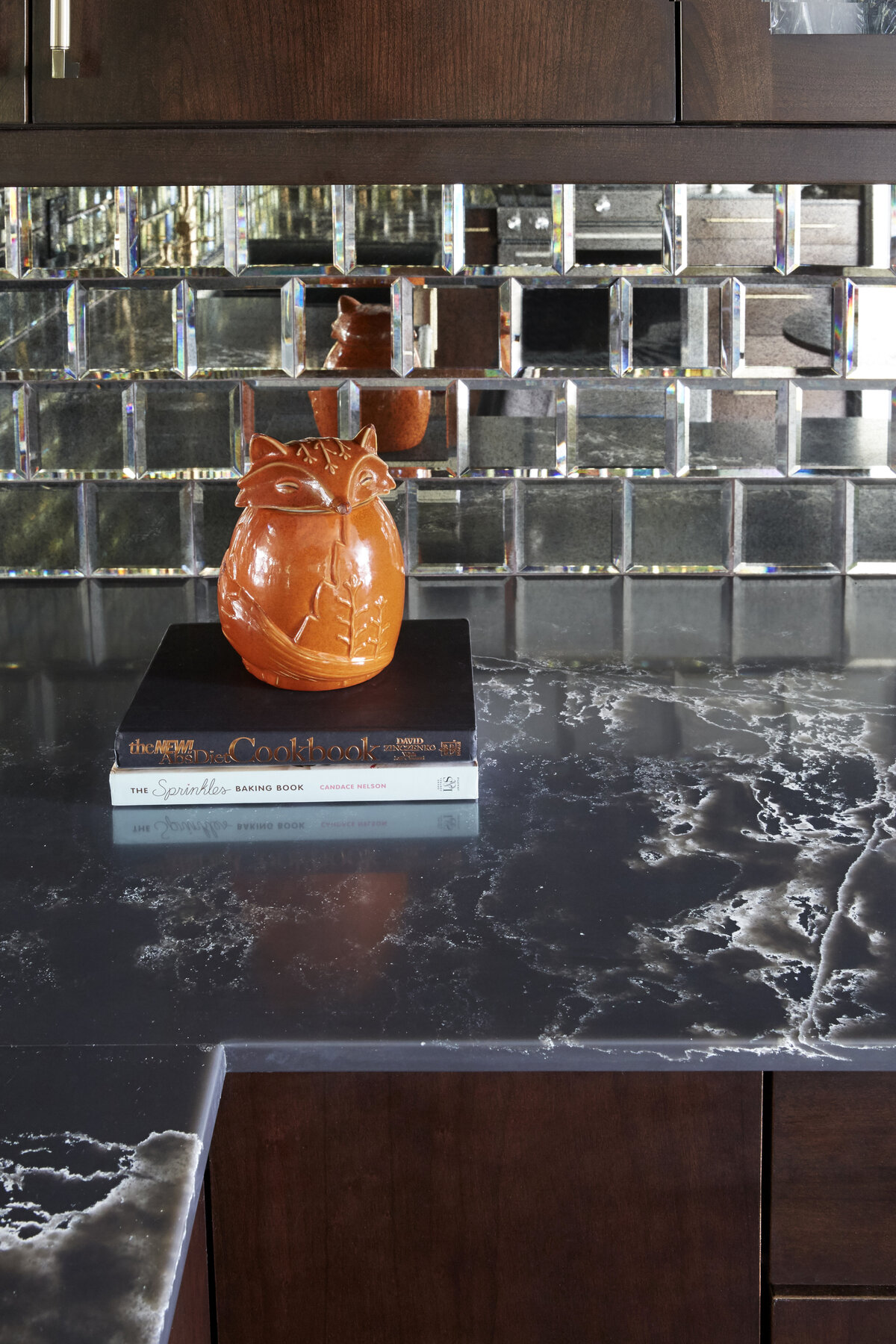 Modern Mirror tiled Kitchen With Brown Cabinets