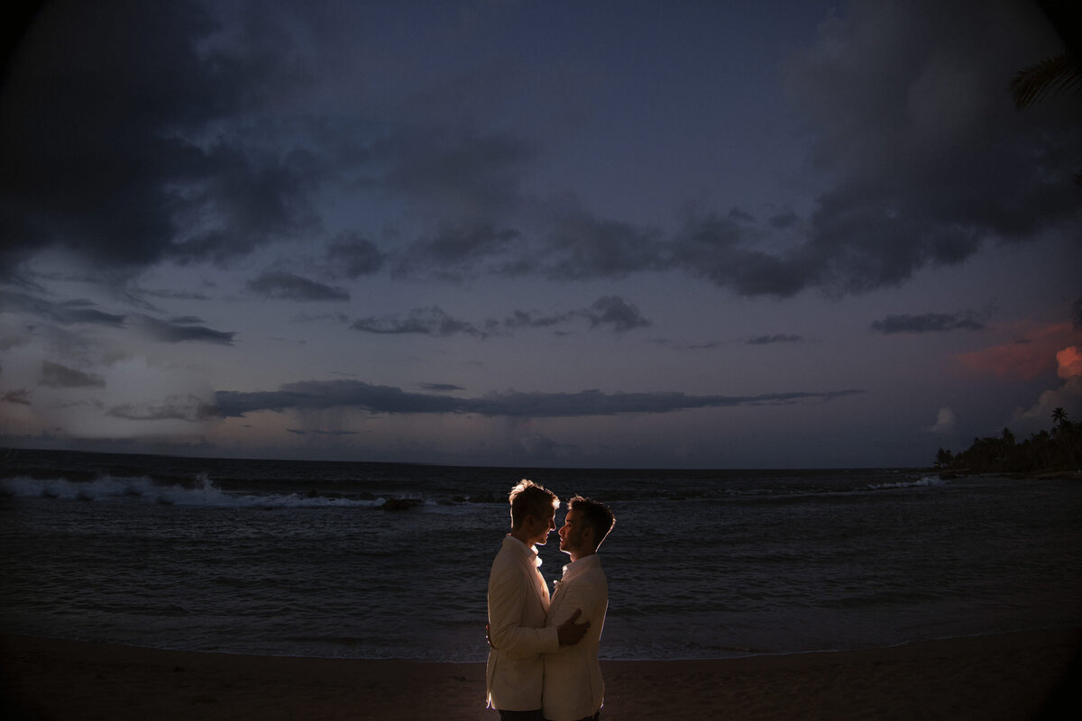A couple takes pictures at sunset  at a destination wedding in Puerto Rico
