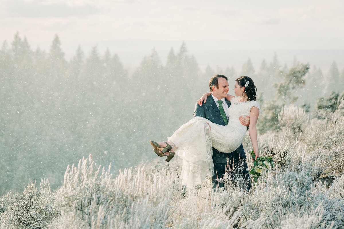 Winter in Jackson Hole a bride and groom surrounded by falling snow romantic and classy