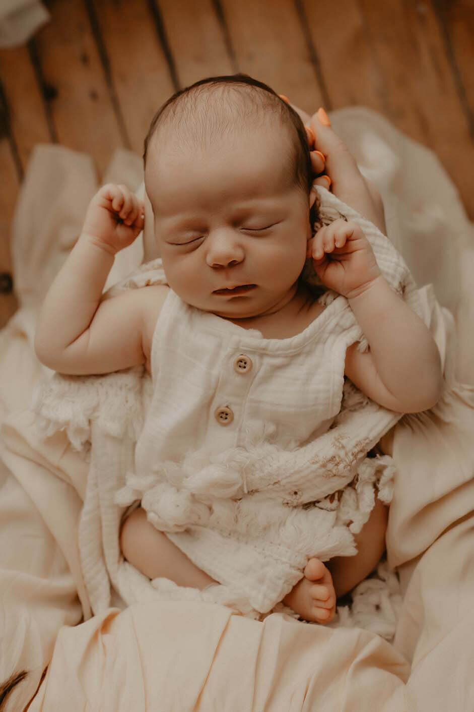 a beautiful newborn girl asleep in her mothers lap