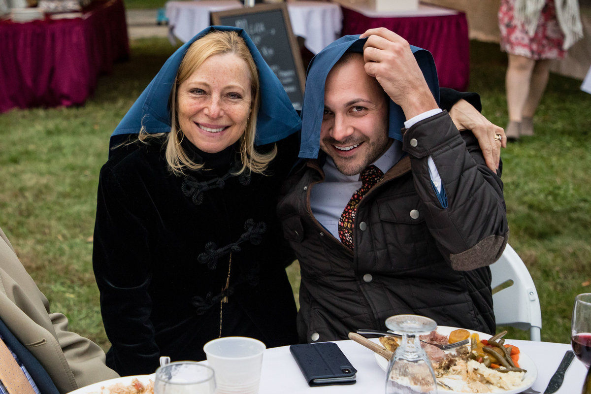 guests with cloth napkins over heads in rain